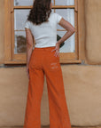 sustainable organic pants. orange corduroy pants. 70s inspired wide leg pants.