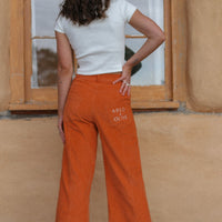 sustainable organic pants. orange corduroy pants. 70s inspired wide leg pants.
